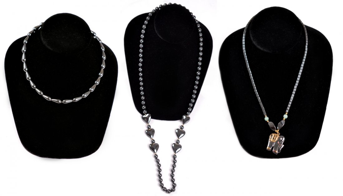 Three Beaded Hematite Necklaces: Comprises: 1.) Cylindrical beaded necklace with jade accents and elephant pendant. [17 1/2" L]. 2.) Spherical beaded necklace with six heart-shaped bead accents [30" L]. 3.) Tear-drop beaded necklace.