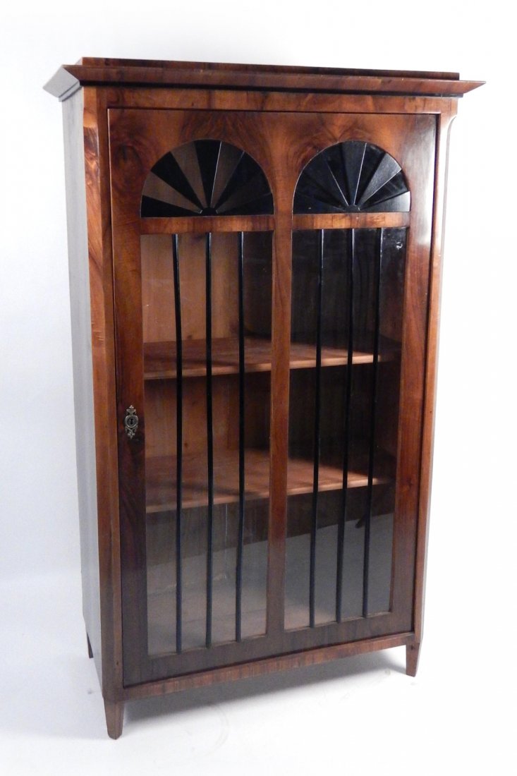 Biedermeier Vitrine Bookcase: 19th Century one-door cabinet with ebonized sunburst trim. [41 1/2" W x 19 3/4" D x 67 1/4" H]. Some scratches. Overall good condition.