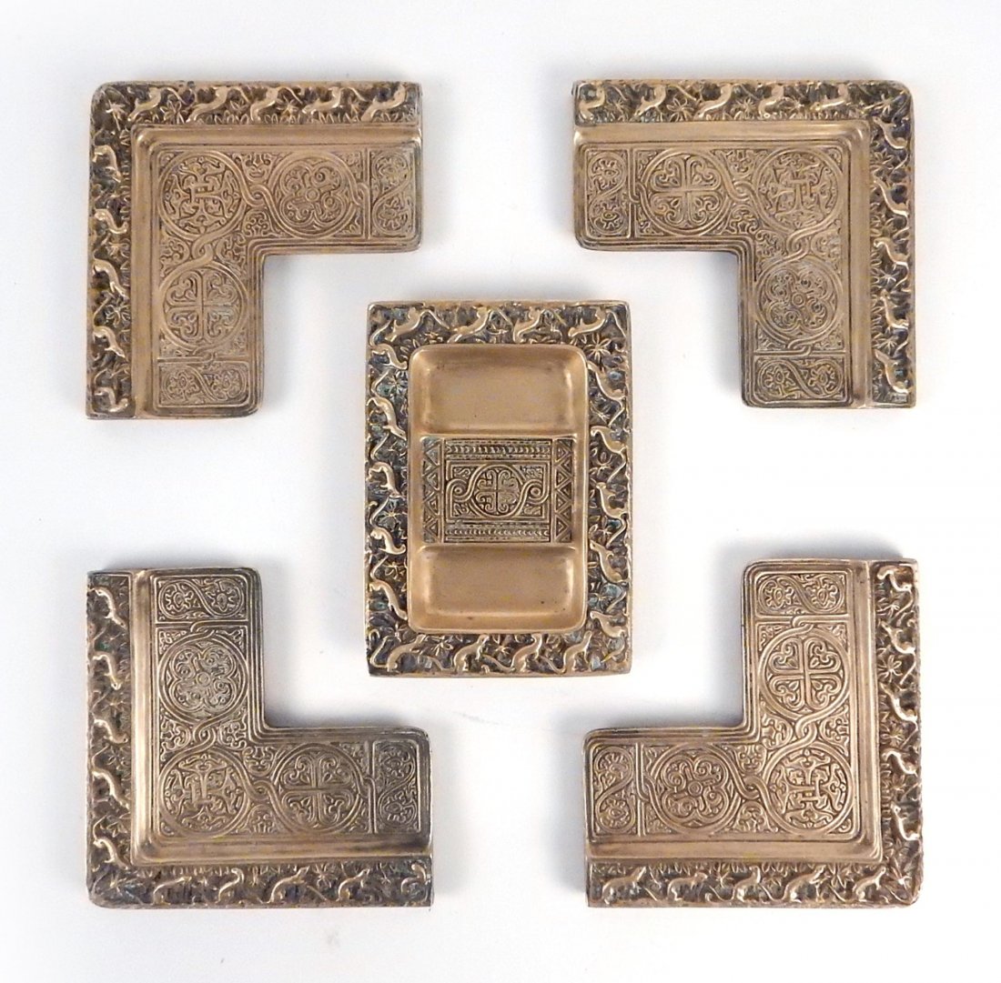 Tiffany Studios "Venetian" Desk Set: Comprises: 1.) 4 bronze blotter corners, all stamped "Tiffany Studios/New York" with three numbered "1694" and one numbered "1696". [4 13/16" x 4 13/16" x 1/4"]. 2.) Partitioned tray stamped on bottom
