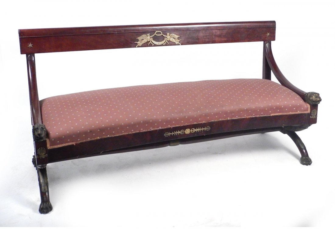 Regency Lion, Star Decor Settee: 19th Century mahogany settee in the manner of Lannuier, with rose upholstery, the arms ending in lion heads with star appliques, and paw feet. [70" W x 27" D x 36" H (back); 17 1/2" to seat].