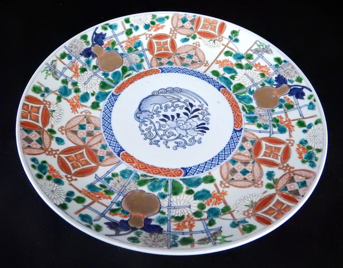 Asian Porcelain Charger: Large Asian porcelain charger of ironstone red, blue, green, and gilt with gourd motif. [2 1/8" H x 16" Dia]. Good condition.