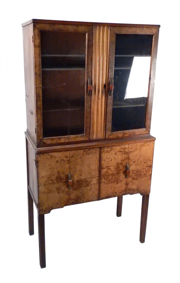 Art Deco Dining Cabinet: Bears two doors below a cabinet with glazed doors bearing etched horizontal strip accents. Upper cabinet contains three shelves. All doors retain original steel and Bakelite pulls. [32" W x 16" D x 60