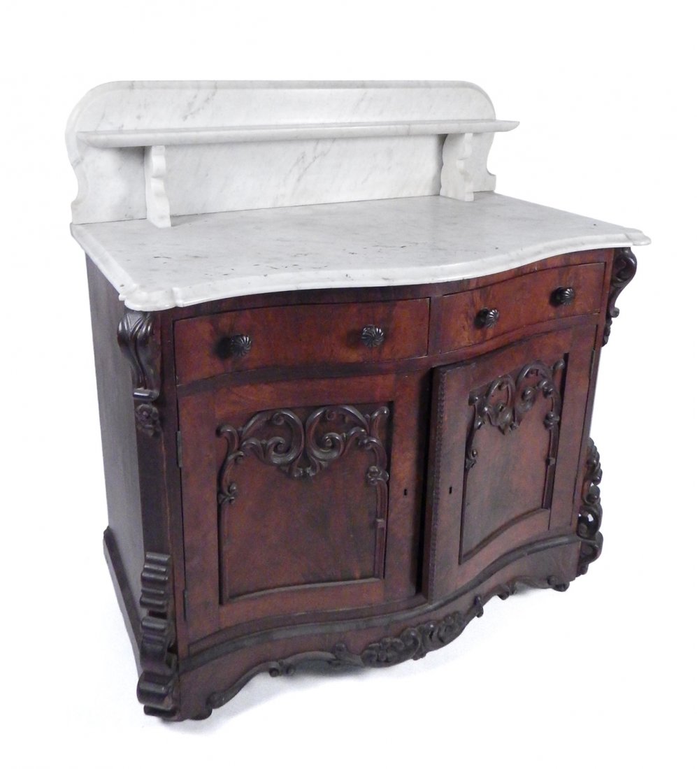 Victorian Marble Top Washstand: Two-door carved washstand with a marble top and backsplash. [36 3/4" W x 18 3/4" D x 36 1/2" H].