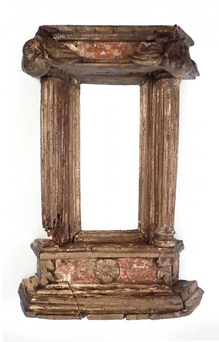 Antique 18th Century Picture Frame: Neo-classical carved and gilt wood frame with column-form sides and pediment with rosette. Features to angel heads at bottom. [Aperture: 9 3/4" x 4"; Overall: 17 3/4" H x 13 1/8" W x 3 3/4" D]. Wear t