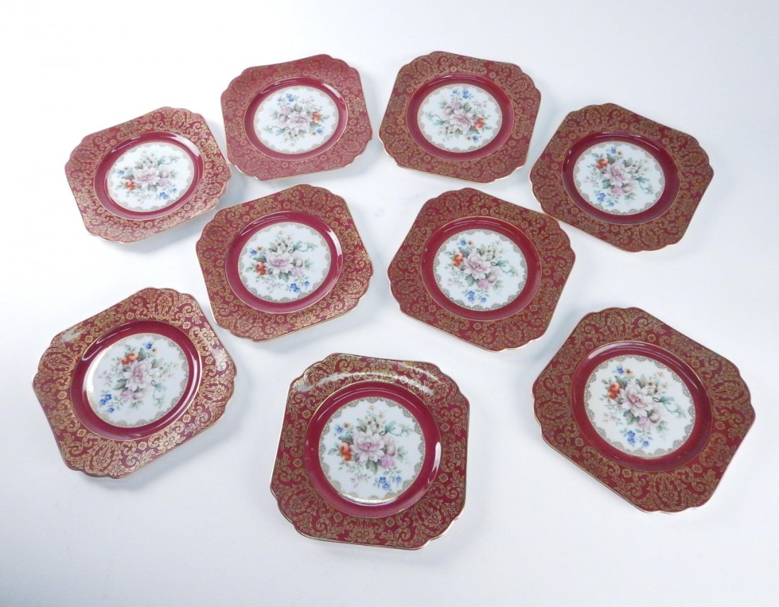Nine Red and Gold Bavarian Plates: Nine floral decorated plates. [9" Dia]. In overall good condition.