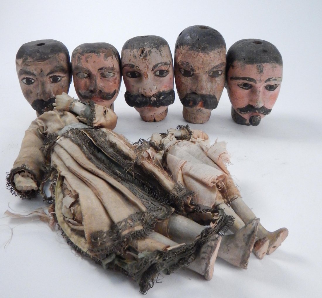 Antique Central American Puppet Heads: Group of five carved wood and polychromed male puppet heads, one with glass eyes. [Sizes from 4 1/8" H to 5 1/2" H]. Accompanied by two partial earthenwear dolls missing heads. Condition varies widely