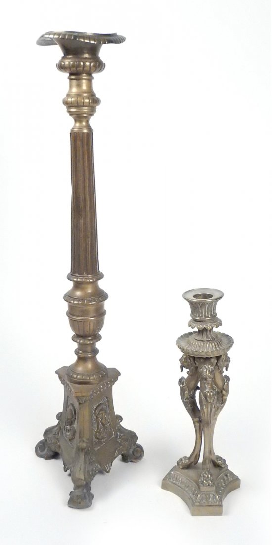 2 Bronze Renaissance-Style Candlesticks: Comprises: 1.) Candlestick on tripod carytid lion suppports. Stamped on bottom "J.C./XI/15". [3 3/4" Dia x 9 3/4" H]. One support loose. 2.) Column-form pricket stick on triangular plinth base with Ho