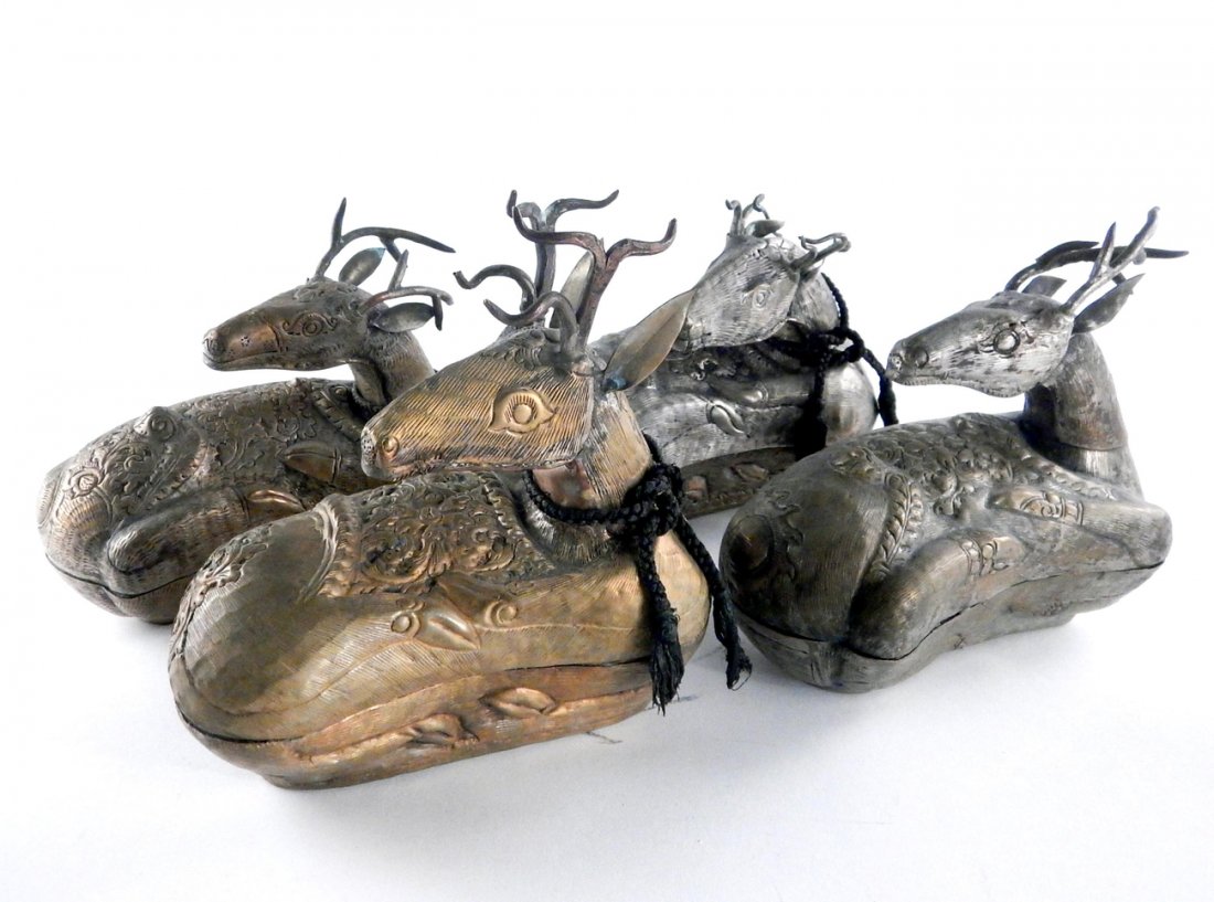 Four Asian Repousse Reindeer Boxes: Copper, brass, and tin recumbent reindeer-form boxes. Each bears ornate decorative accents throughout. [Largest: 10 3/8" w x 4 1/4" D x 7 1/2"]. Wear with dents and soiling.