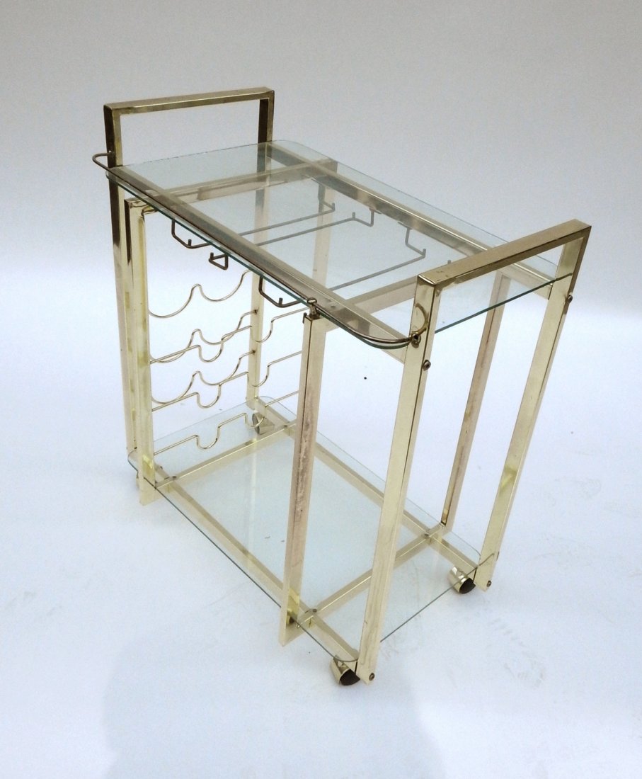 Glass Top Brass Tea Cart: Two-tier tea cart with glass shelves and wine rack. [25 1/2" H x 30" W]. Scuffs, abrasions.