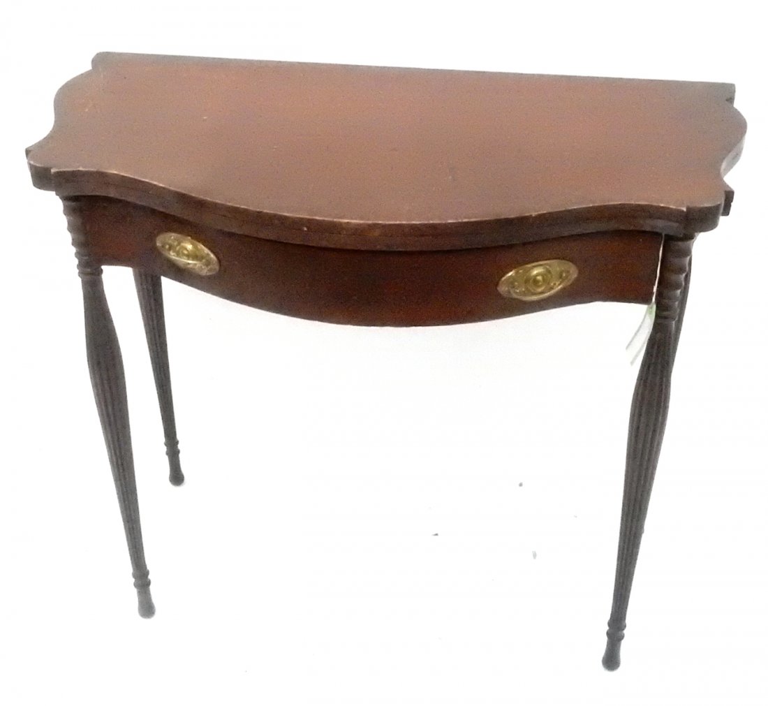 Sheraton-Style Game Table: Serpentine one-drawer lift-top game table with reed-form legs. [35 1/2" L x 19" D x 31" H]. From Martin Parker / Spencertown Art and Antique Company.
