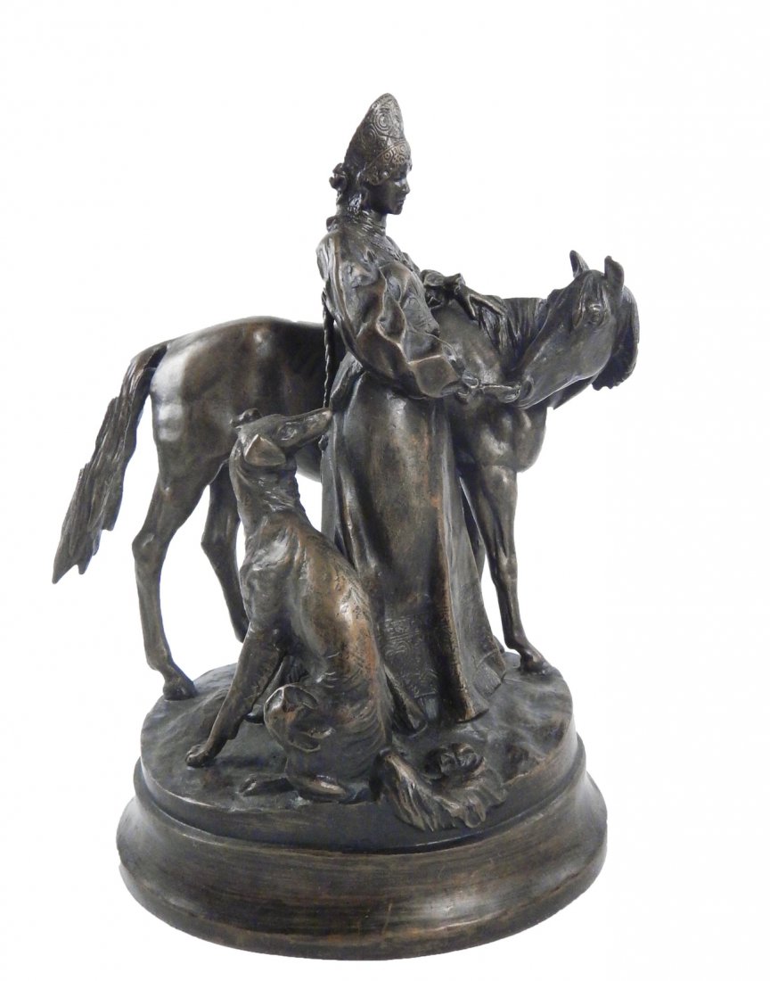 Vintage French Bronze Figural Group: Depicts a woman in ornate Eastern European folk costume feeding a horse while a dog looks on. Signed on ground illegibly. [9 3/4" W x 6 3/4" D x 11" H]. Bears dark brown patina.