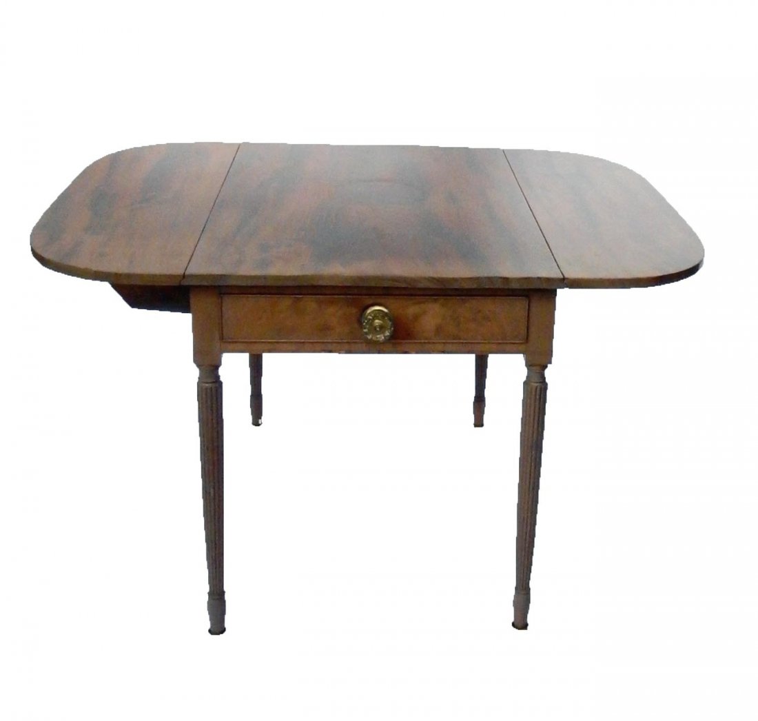 Maple Sheraton-Style Pembroke Table: Drop-leaf table on reeded legs tapering toward bottom with caster feet. Missing one pull on faux drawer at back. Sun stain on front and top. [22 1/4" W x 34" D x 27 3/4" H (closed); Open: 44" W].