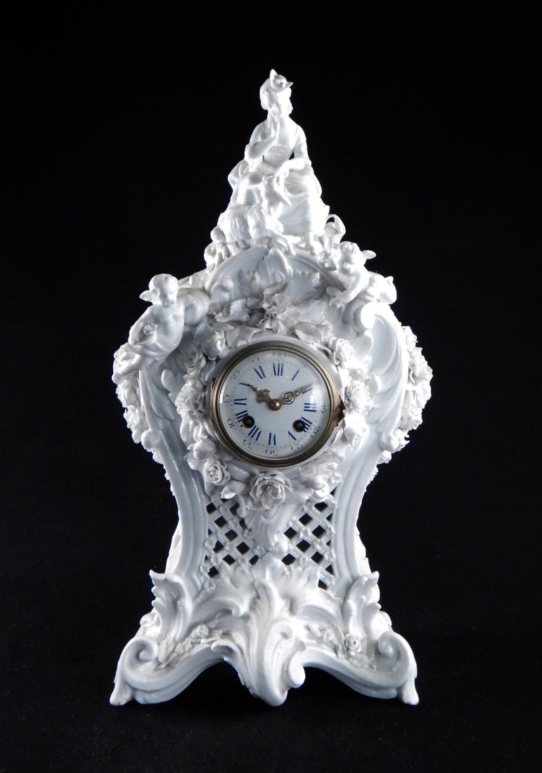 18th C. French-Style Mantle Clock: French-style ceramic mantle clock with white glaze and brass hardware. Bears surface grime, minor chips. Untested.