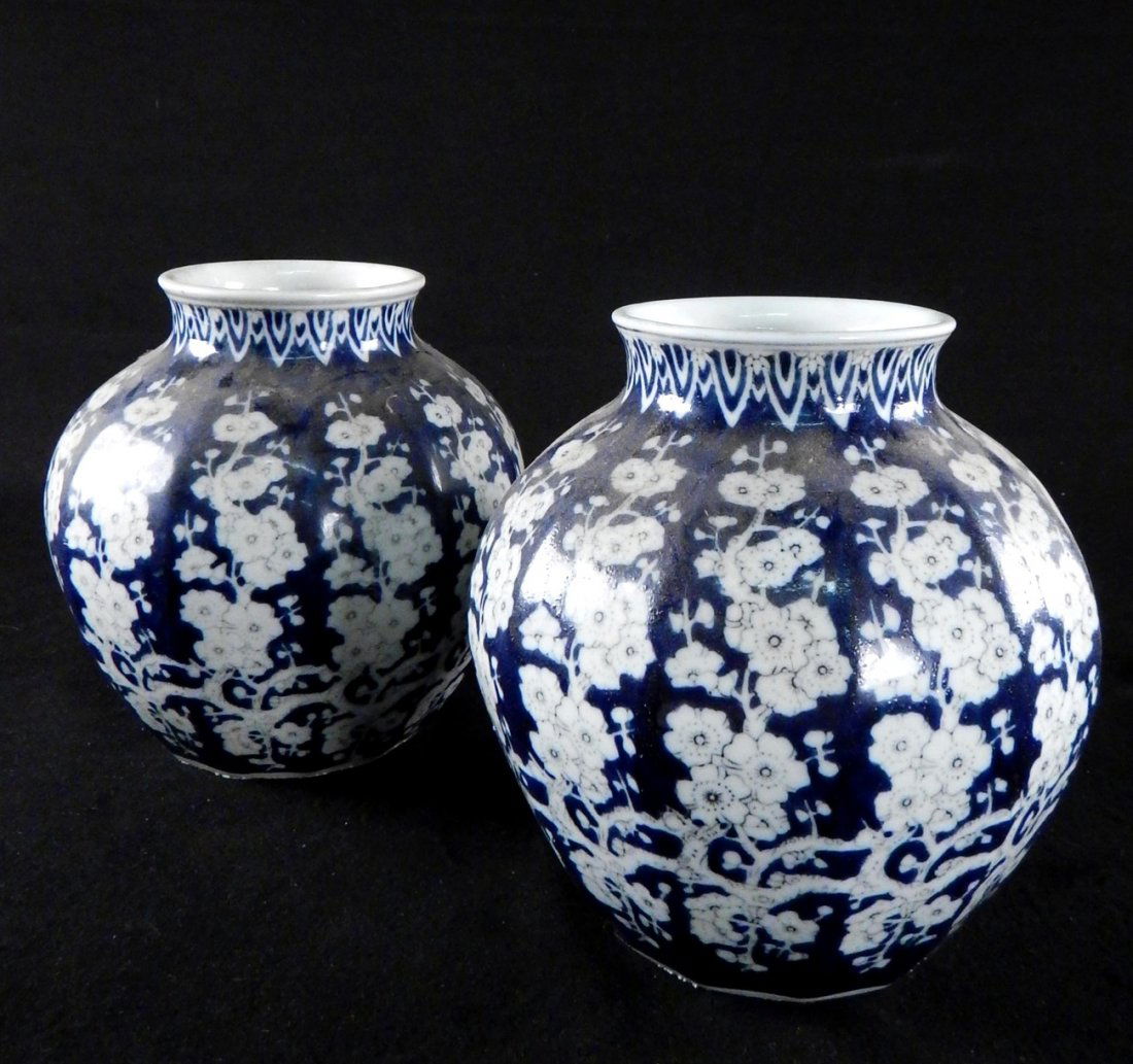 Pair of 20th C. Blue and White Vases: Bear slightly pleated surface. Deep blue ground with white flowers and design. [8" Dia x 8" H]. Light wear.