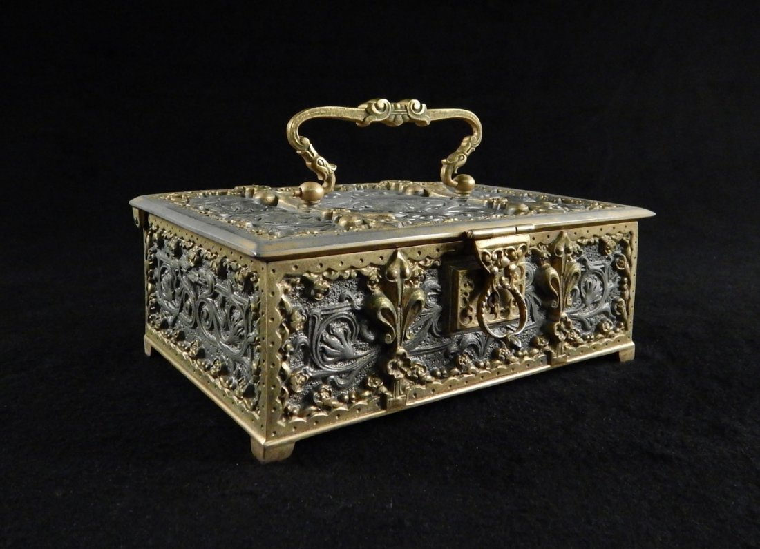 Bronze Doré Jewelry Box: Ornate jewelry box with doré handle and borders. Key included. [7 3/4" W x 5 1/4" D x 3 1/2" H]. Light wear.