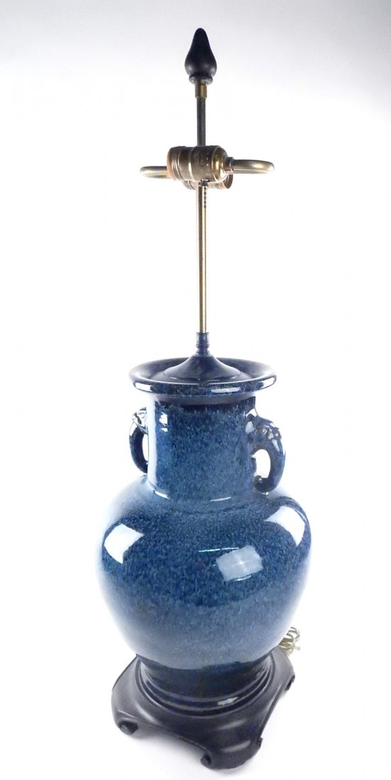 Handled Vase-Form Ceramic Table Lamp: Large blue ceramic vase with elephant trunk handles at neck, converted to table lamp with wood base and brass hardware. [11 1/2" Dia x 32" H to top]. Untested.