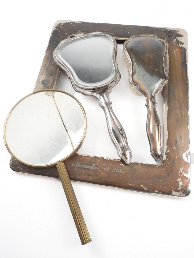 3 Silver Items: Comprising a silver brush, a mirror, and a frame.