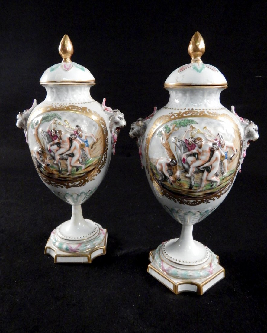 Pair of Capodimonte Covered Urns: Pair of decorated vases, one with a broken finial on the cover. [11 1/2" H].