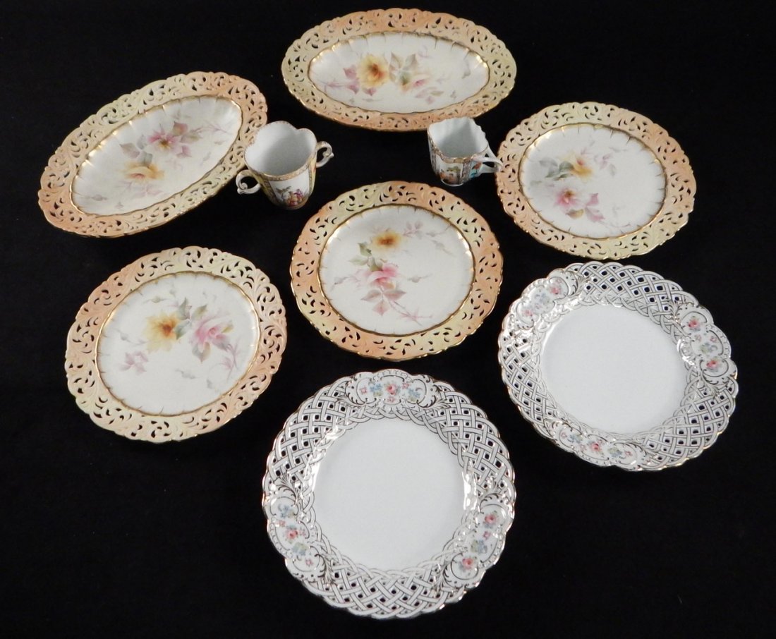 9 Porcelain Items - 7 Plates, 2 Teacups: Comprising 3 Royal Worcester plates, 2 oval bowls, 2 reticulated floral decorated plates, and 2 teacups (one Meissen).