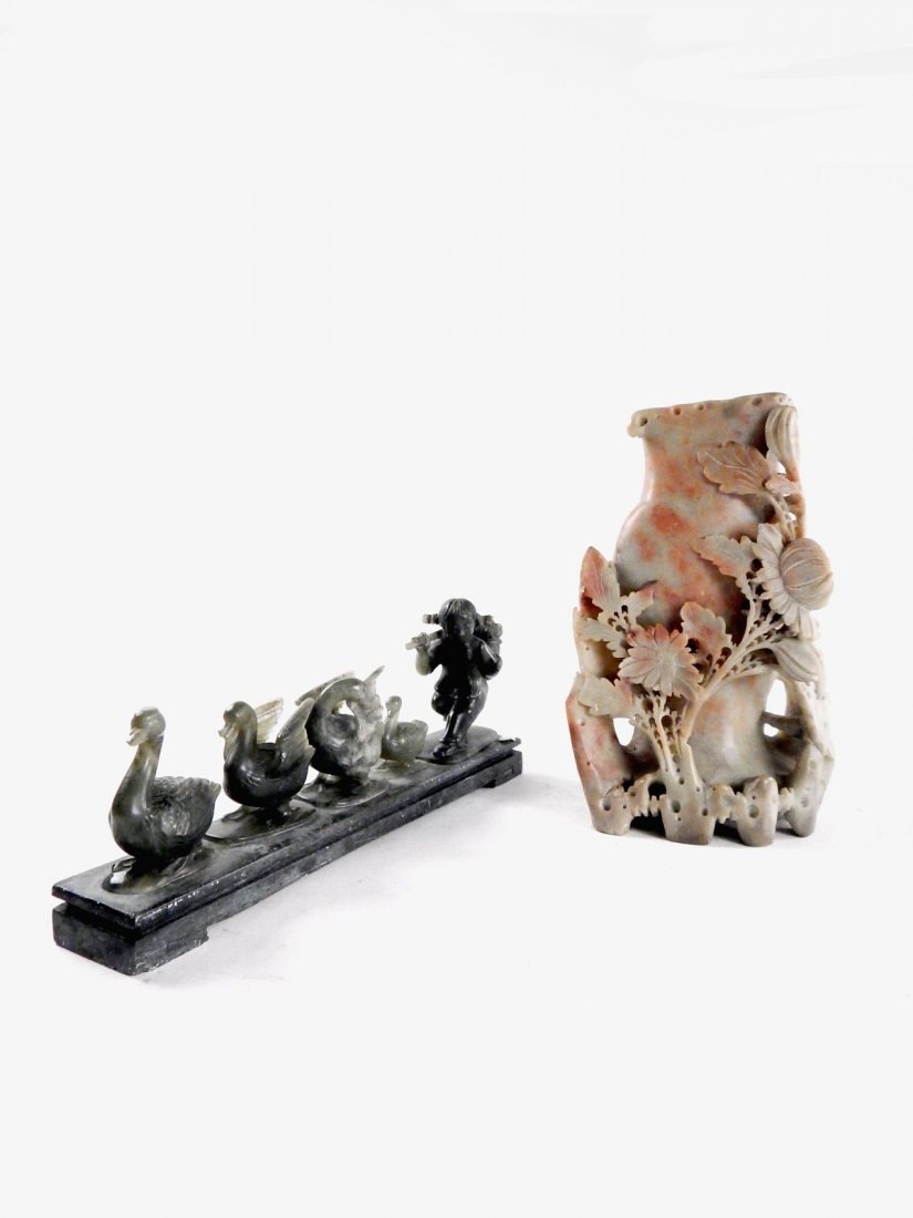 Two Asian Sculptures: Comprises a soapstone floral carved vessel and a sculpture of a figure holding a satchel walking with ducks. [10 1/4" L x 2" D x 4" H; Vessel: 8" H].