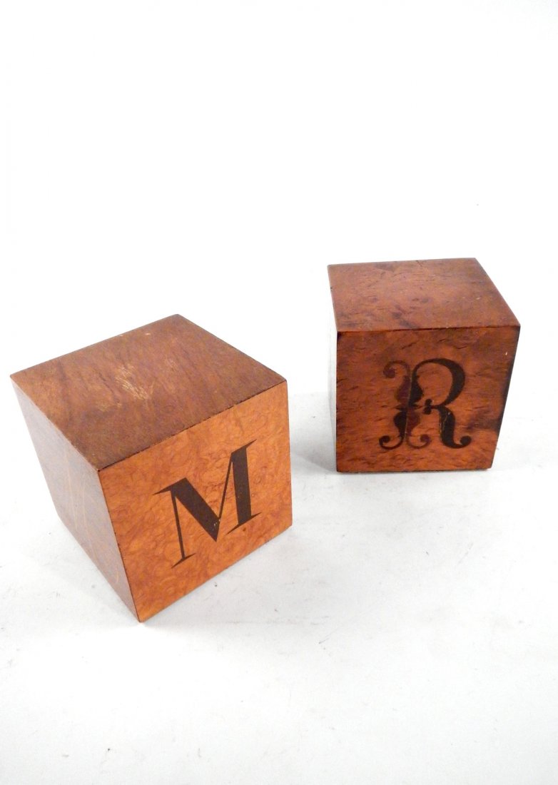 Two Andrew Szoeke Letter Cubes: Cubes featuring contrasting marquetry inlay depicting the letters 'M' and 'R' in multiple fonts. Both are four inch cubes and labeled on bottoms. Wear and scuffs.