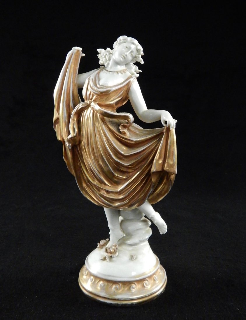 Capodimonte Porcelain Figure: Depicting female dancer in gold dress. [5" W x 3 1/4" D x 9" H]. Chips throughout.