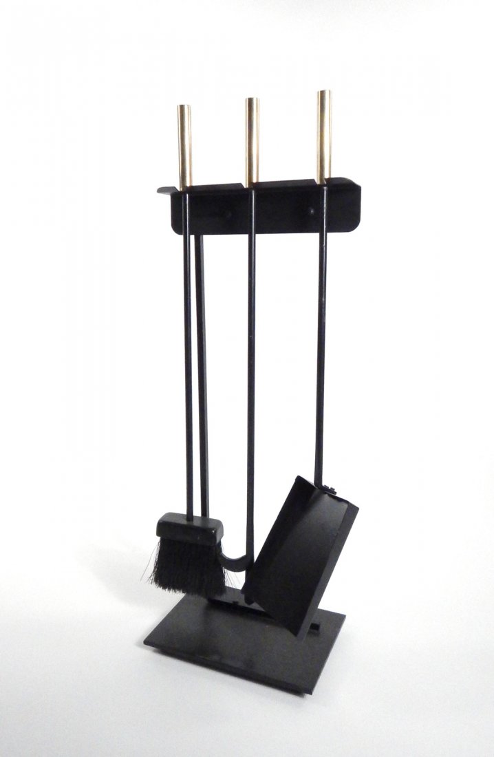 Mid-Century Modern Fire Tool Set: Blackened steel fire tool set with brass handles and cantilevered stand. Comprises brush, ash pan, and poker. [Overall: 10" W x 6 1/2" D x 28 1/4" H]. Some wear.