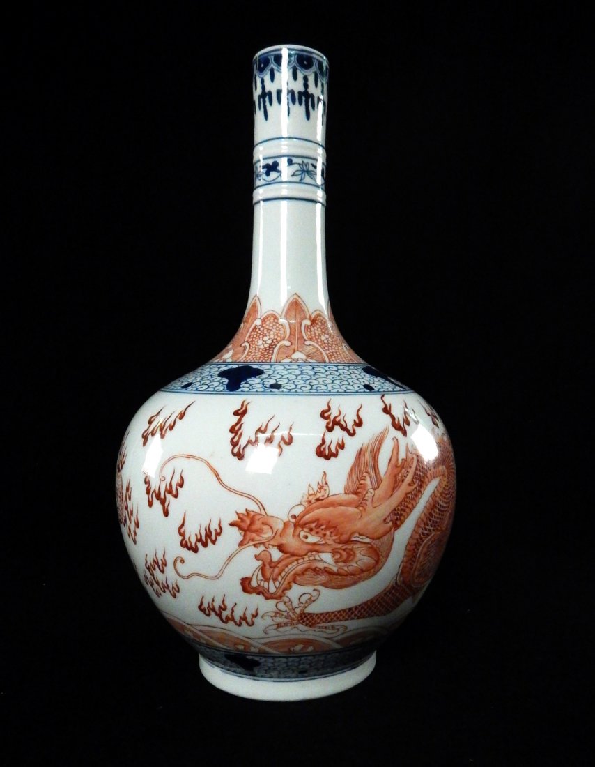 Chinese Vase with Dragon: Chinese blue and ironstone red porcelain vase with hand-painted dragon decor. [13" H x 7 1/2" W]. In good condition.