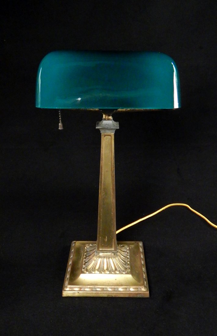Brass and Emerald Shade Desk Lamp: Brass library/banker's lamp with emerald green shade. [17 1/2" H x 6 3/4" x 6 3/4"]. Brass bears pitting.
