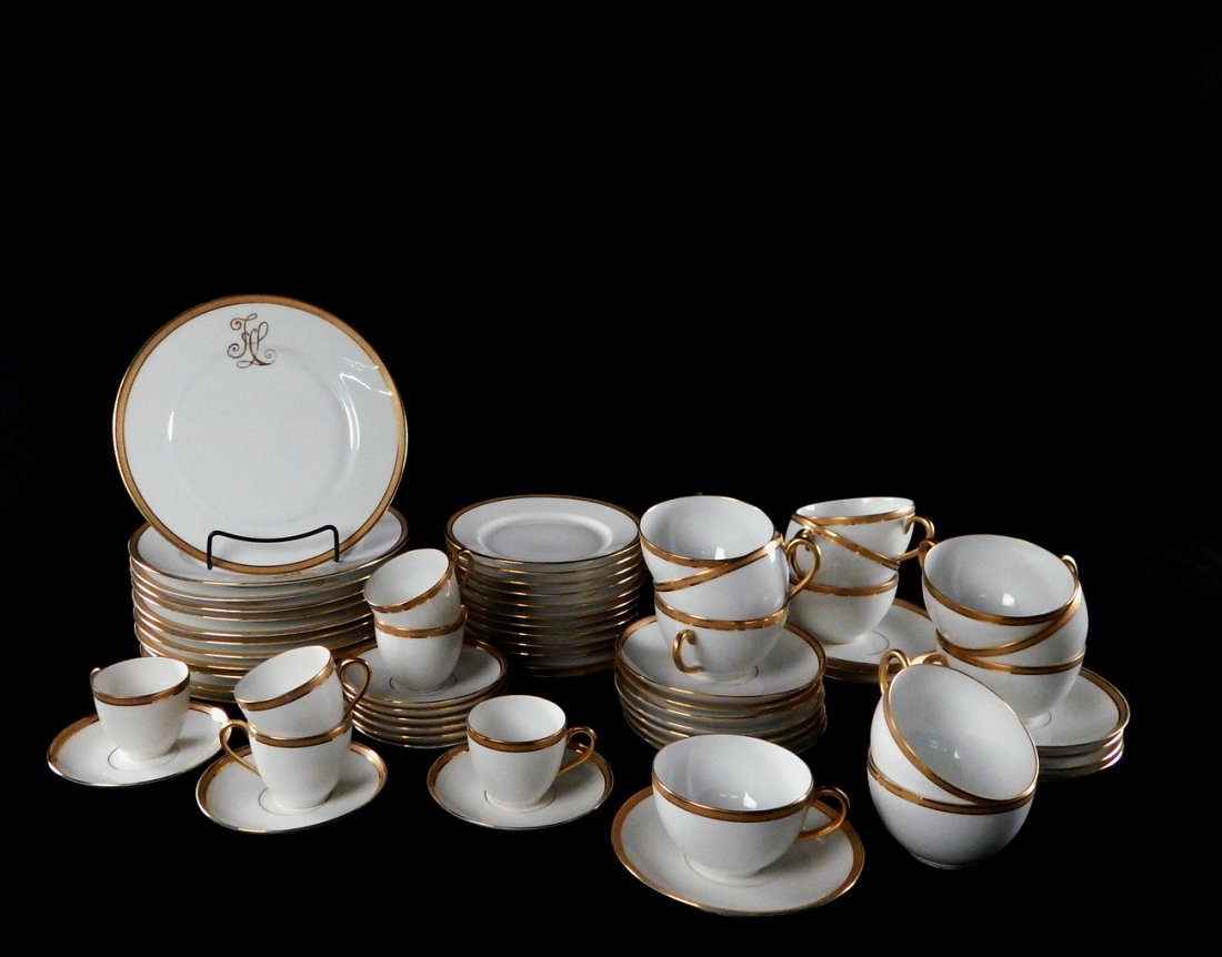Limoges Porcelain Plates, Saucers, Cups: Comprised of 12 hors d'oeuvres plates, 12 dessert plates, 6 demitasse cups with 9 saucers. All white with gold trim, dessert plates bare monogram. [Dessert plates: 8 1/2" Dia]. Light wear, minor chips