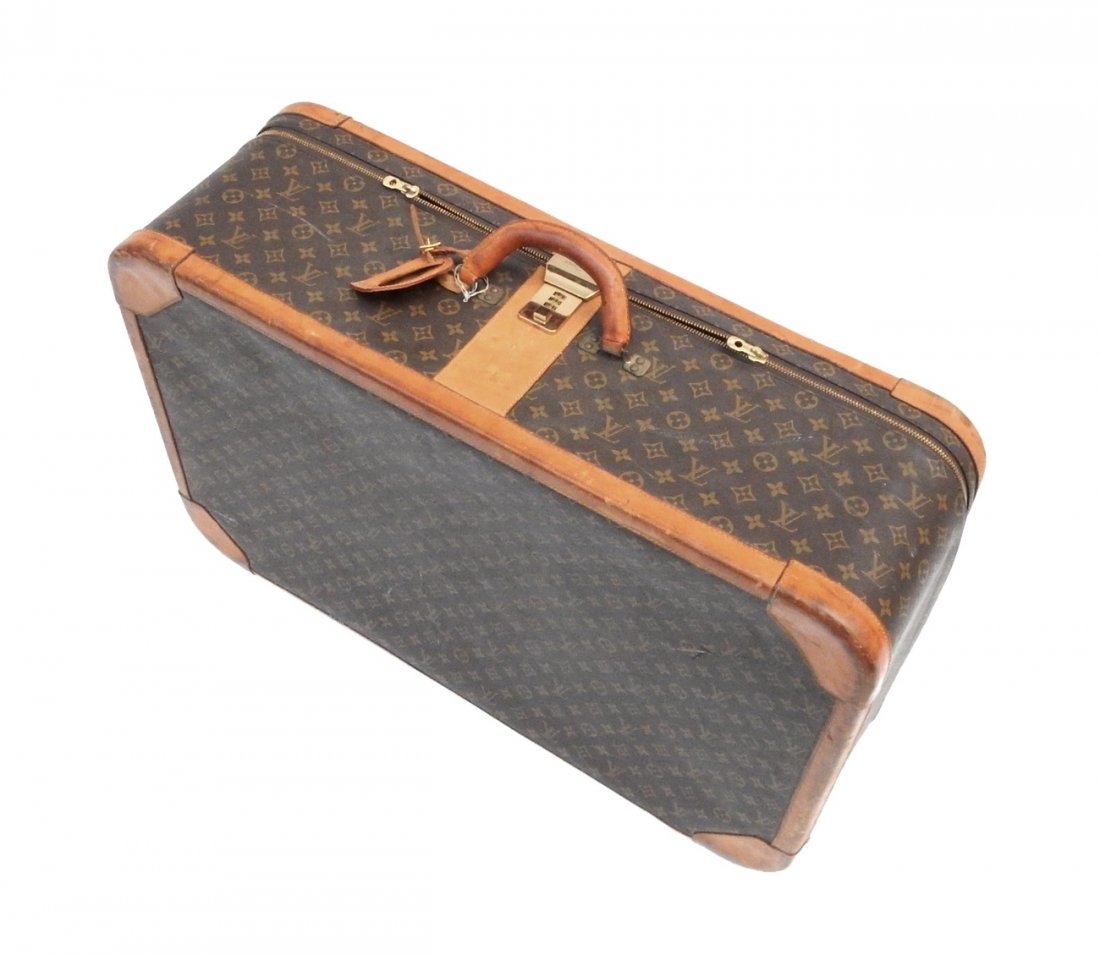 Vintage Louis Vuitton Suitcase: Featuring a number code lock stamp "Louis Vuitton Paris". Suitcase locked, code unknown. [31" W x 10 1/2" D x 20" H]. Abrasions and scuffs from use.
