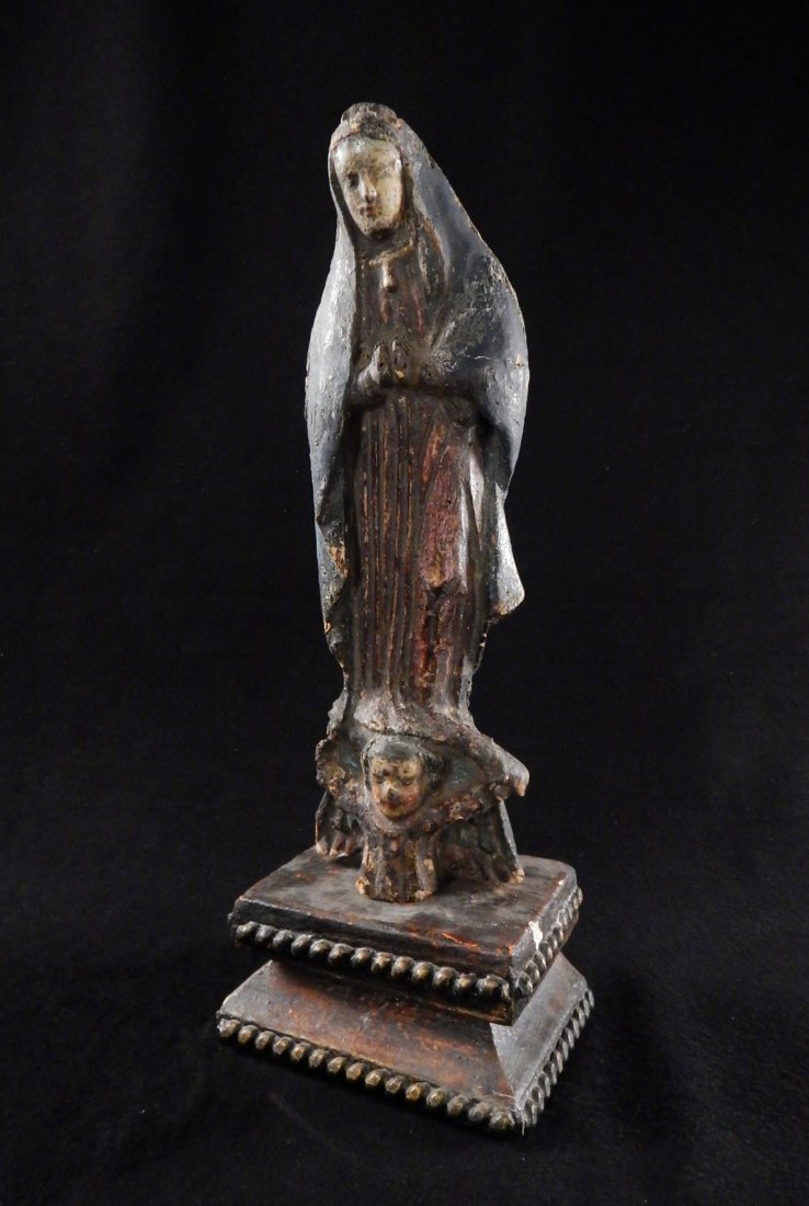 Antique Spanish Colonial - "Santos": Featuring a saint, possibly the Virgin Mary, with angelic figure at the base. Rests on original pedestal. [Figure: 5" W x 3" D x 16" H; Pedestal: 7 1/2" W x 5 1/2" D x 3 1/2" H]. Abrasions, losses and