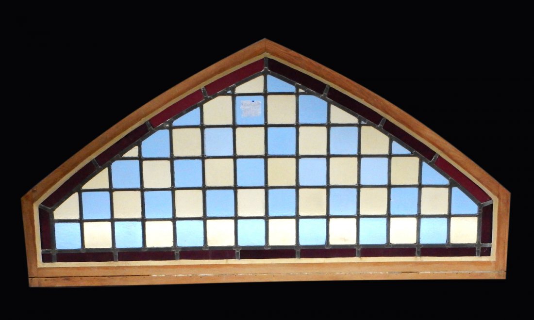 Stained Glass Transom: Multicolored stained glass transom. [66 1/2" L x 2" D x 34" H].