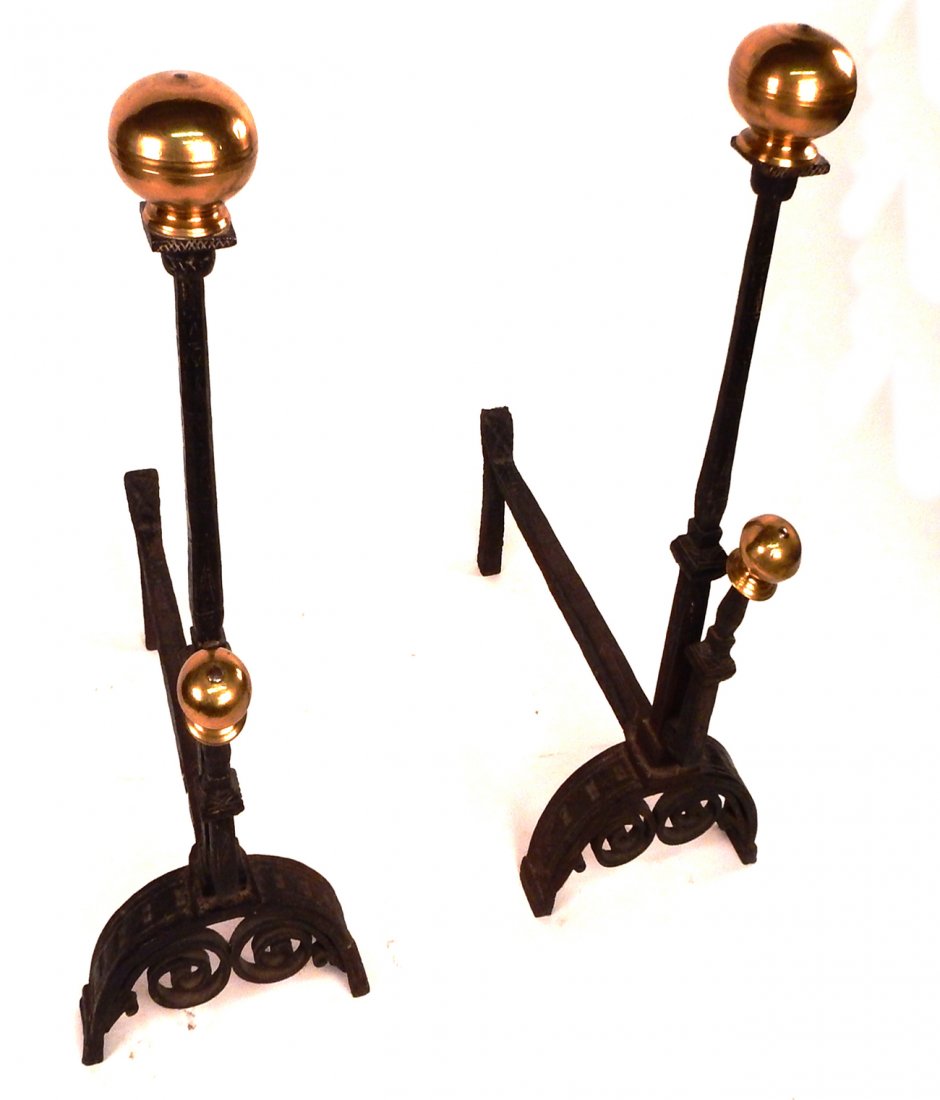 Pair of Wrought Iron and Brass Andirons: Pair of wrought iron and brass andirons with Arts and rcafts / deco designs. [25" L x 12" W x 34 1/2" H]. In good condition.