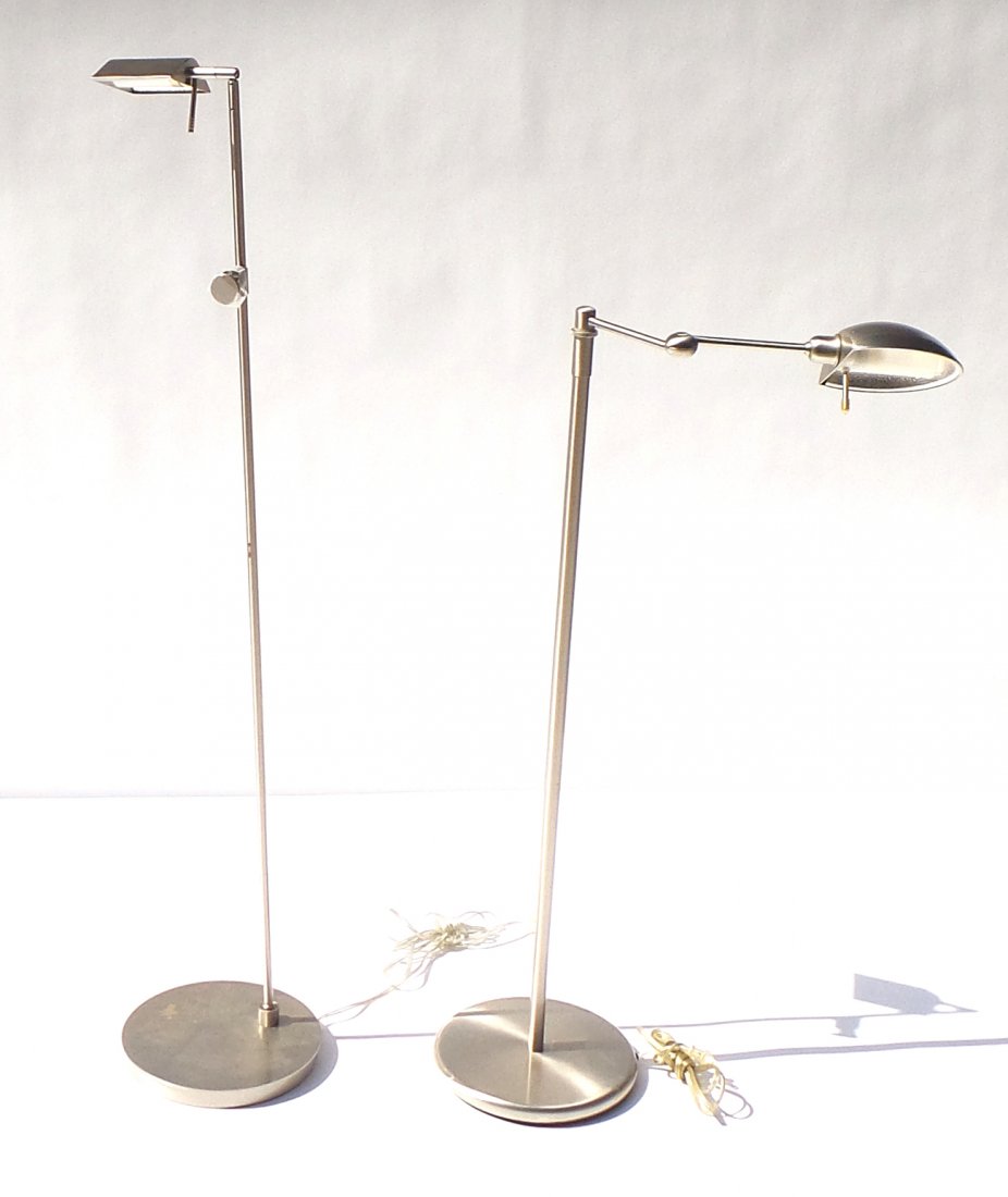 Two Modern Nickel-Finish Floor Lamps: Ceremonial mask with alligator issuing from mouth. Features shell, boar's tusk, feather, and natural fiber details. [24 1/2" W x 8" D x 78 1/4" H]. Some losses and wear.