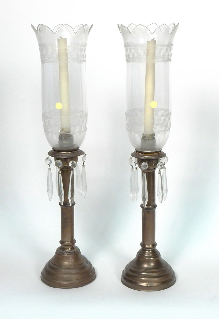 Pair of Luster Candlesticks: Featuring hurricane shades, hanging glass spear prisms, copper shaft and base. [4 3/4" Dia x 21" H]. Dents, wear commensurate with age.