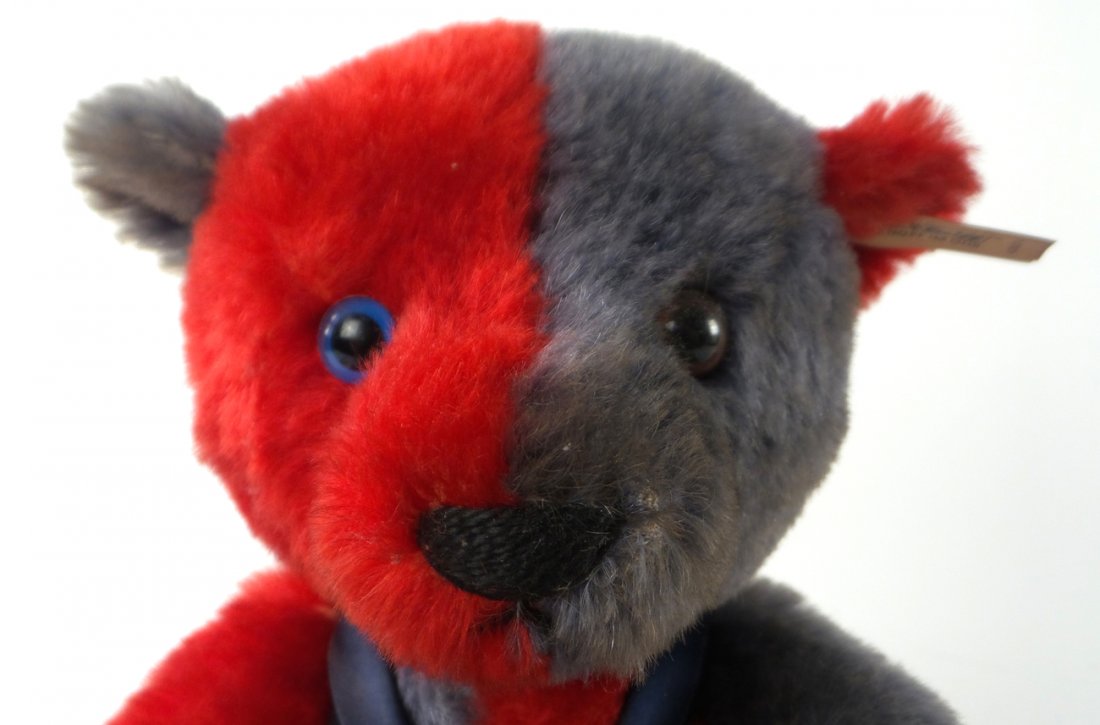 Steiff Club Teddy Bear: A red and grey teddy bear with a Steiff club pin and marked in one ear. [7" x 10" H]. Appears to be in good condition.