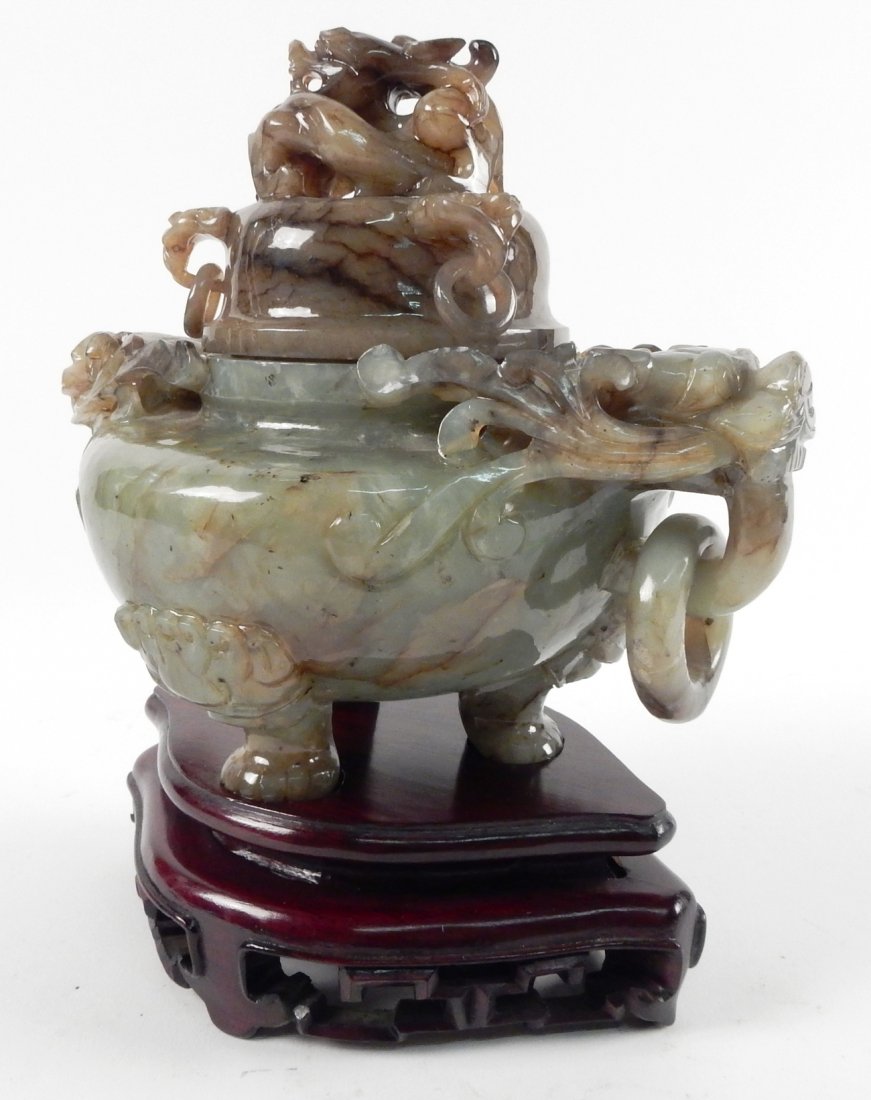 Jade Incensor on a Wood Stand: Featuring a foo lion motif with multiple rings. [7" W x 5" D x 7 1/2" H]. Previous repair.
