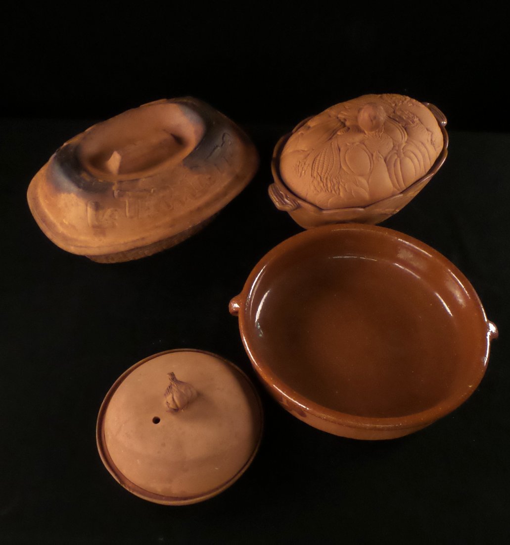 Glazed Interior Terracotta Cookware: Comprises: wide flat bottom bowl [13" Dia]; covered casserole [13" W x 9 3/8" D x 3 1/2" H without lid]; circular covered garlic roaster [8 1/4" Dia]. All exhibit wear and discoloration. 4 items total