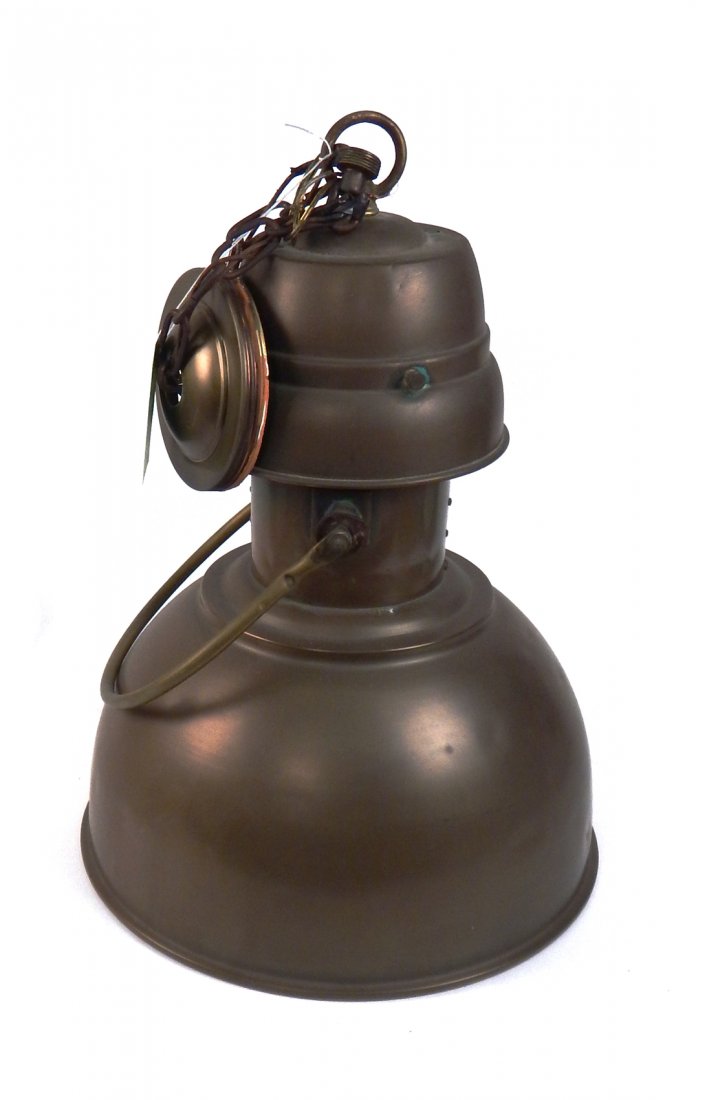 Patinated Aluminum Hanging Fixture: Unusual bell-shaped fixture with a glass shade under an outer patinated structure. Brass hardware. [14 1/2" Dia x 18 1/2" H]. Dents, nicks, oxidation.