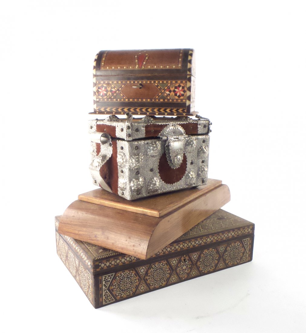 Four Boxes, Moroccan and Others: Four boxes comprising: 1.) Moroccan box with inlaid geometric design. [12" x 7 3/4" x 2 3/4"]. 2.) Moroccan inlaid domed box with key. [4" x 7" x 4 1/2"]. 3.) Wood playing card box. [12" x 6 1/4" x 2