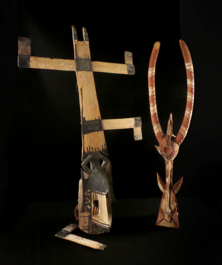 Two Carved and Painted African Masks: Two carved and painted African wood masks, one depicting a mythological beast with horns and stylized teeth. Both anthropomorphic. [8" x 8" x 36" and 39" x 24" x 8"]. "As is". Top of carved wood horn 