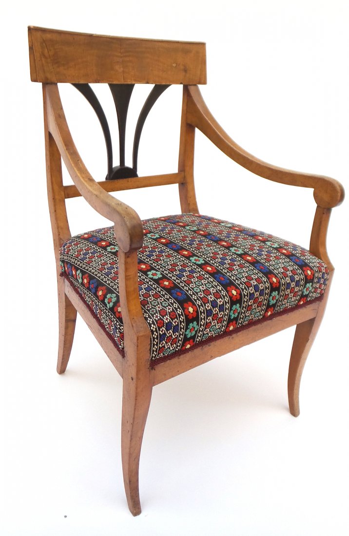Single Biedermeier Arm Chair: Walnut open arm chair on splayed legs with ebonized back splat. [21 1/4" x 19 1/2" x 33 3/4"]. Wear throughout.