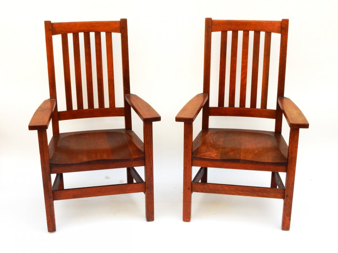 Pair of Stickley Bros. Armchairs: Oak Arts and Crafts-style armchairs by Stickley Bros. [27" W x 21" D x 17" H to seat; 42 1/2" H to top]. Nicks, scratches, light wear.