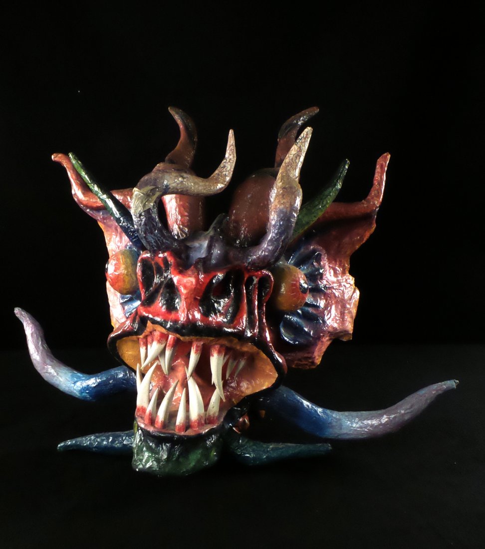 Papier Mache Dragon Head: Colorful elaborate dragon head with building eyes and snarling teeth. [30" w x 13 1/2" D x 24" H]. Light wear. One horn.