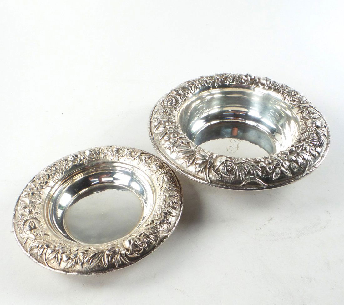 Two S. Kirk & Son Sterling Wine Coasters: Comprises: 1.) Jeroboam coaster with wide rim bearing chased repousse leafy floral decor. Center bears engraved letter "J" monogram. [9 5/8" Dia x 2 1/2" H]. 2.) Bottle coaster with same pattern as ab