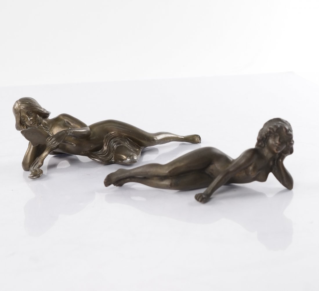 Two Art Nouveau Reclining Nude Figures: Two Art Nouveau reclining nude figures. 1.) Bronze nude. [4 3/4" W x 1 3/4" x 1 1/2" H]. 2.) Metal with bronze finish woman with mirror. [6" W x 2" x 2" H]. Good condition, wear to finish.