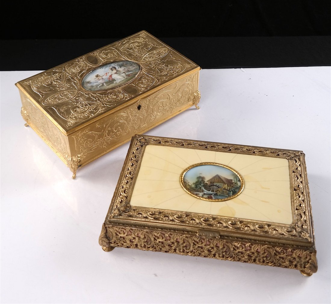 Two Boxes with Painted Medallions: A musical incised box and a filigree-style box, both hinged. [9 1/2" x 6"]. Paint loose from mount, overall good condition.
