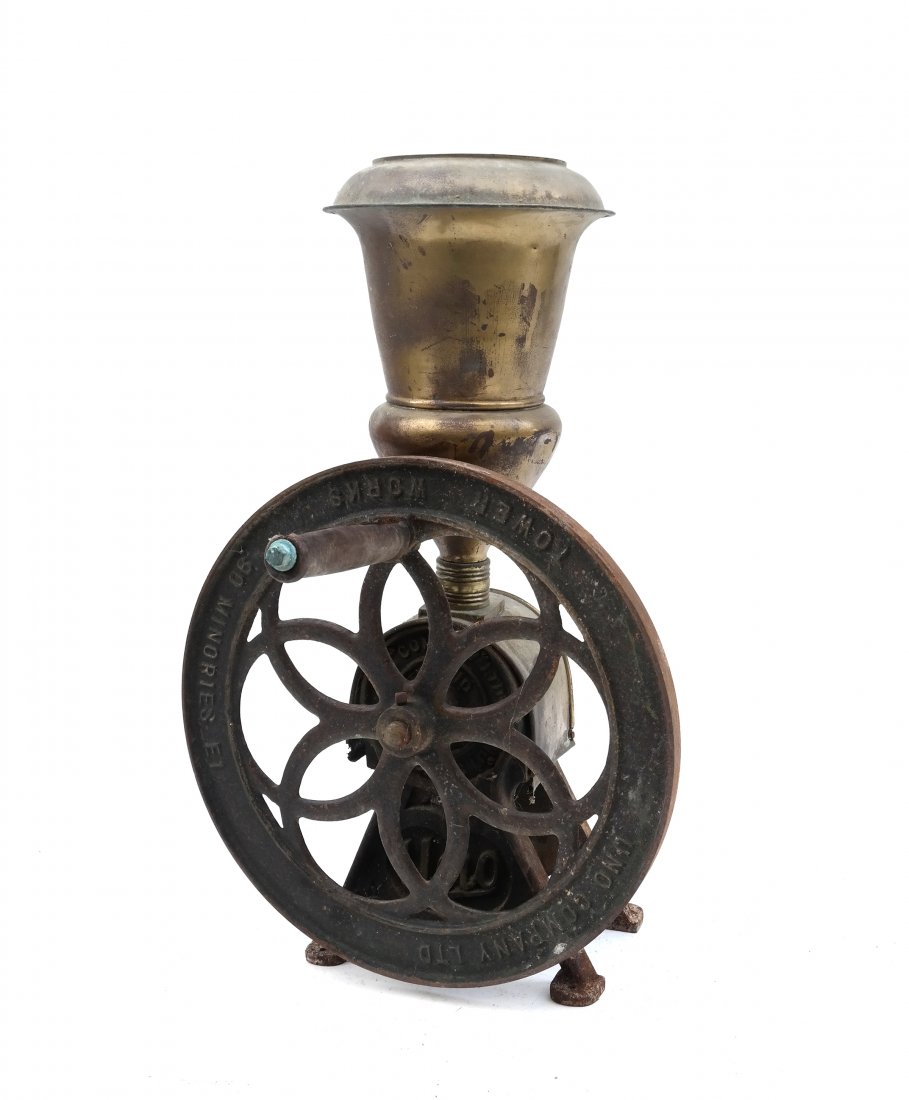 Uno Company Ltd. Coffee Grinder: Brass and cast iron coffee grinder by Uno Company Ltd. [16" x 16 1/2" x 26 1/2" H]. Rust and dents.