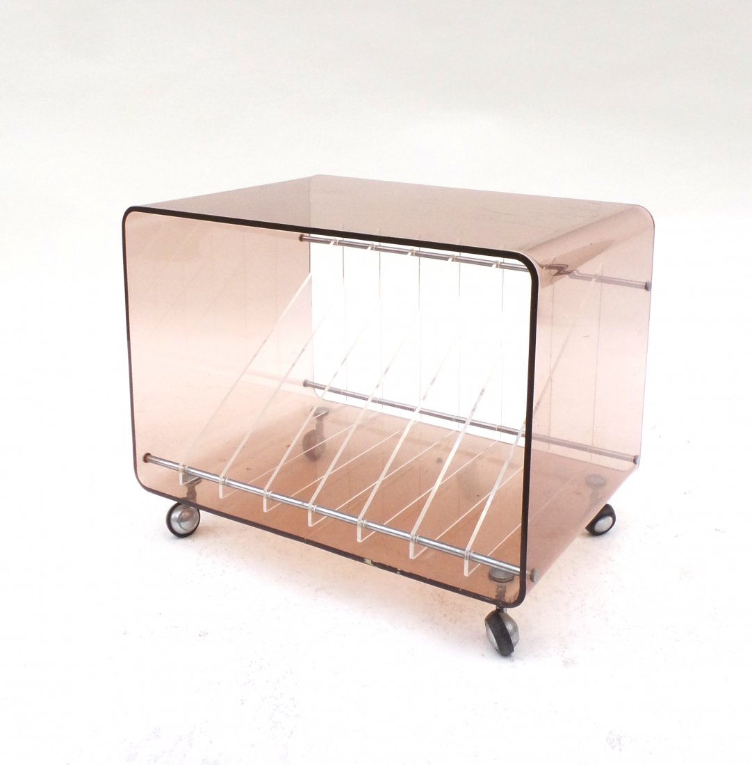 Lucite Magazine Rack: Colored-to-clear Lucite table on casters.